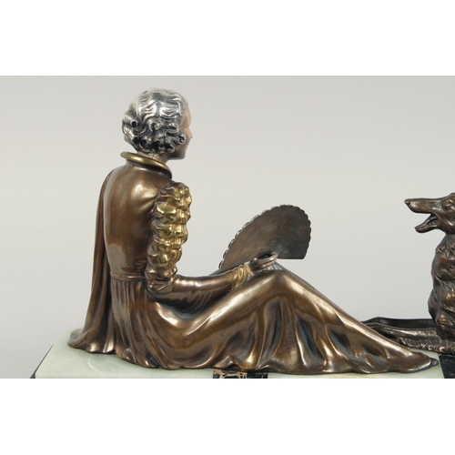 1286 - A VERY GOOD ART DECO BRONZE GROUP OF A LADY SEATED HOLDING A FAN in front of a Borzoi on an inlaid b... 