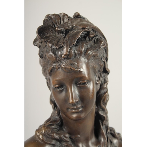 1295 - AFTER MAX BLONDEL. A BRONZE BUST OF A YOUNG LADY. Signed.  15ins high on a circular base.