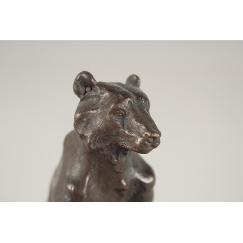 1297 - A SMALL BRONZE OF A BEAR. 5ins high on a marble base.