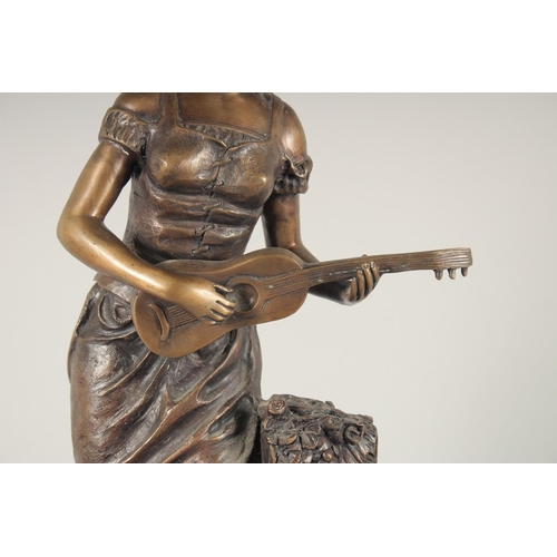 1304 - AFTER A MOIREAU. A LARGE BRONZE OF A GIRL playing a mandolin. 2ft 1ins high on a circular base.... 