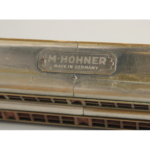 1315 - M. HOHNER. A LONG DOUBLE HARMONICA. 23ins long, in a case.