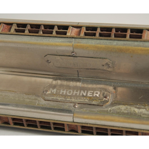 1315 - M. HOHNER. A LONG DOUBLE HARMONICA. 23ins long, in a case.