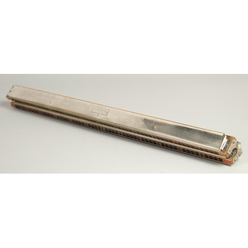 1315 - M. HOHNER. A LONG DOUBLE HARMONICA. 23ins long, in a case.