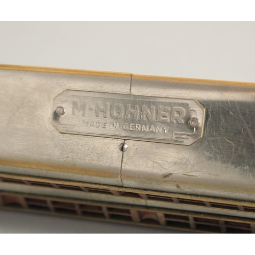 1315 - M. HOHNER. A LONG DOUBLE HARMONICA. 23ins long, in a case.