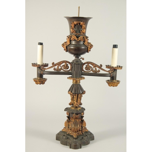 1321 - THOMAS MESSENGER. A REGENCY BRONZE AND ORMOLU TWO LIGHT CANDELABRA with outstretched arms and an urn... 