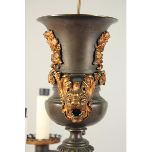 1321 - THOMAS MESSENGER. A REGENCY BRONZE AND ORMOLU TWO LIGHT CANDELABRA with outstretched arms and an urn... 