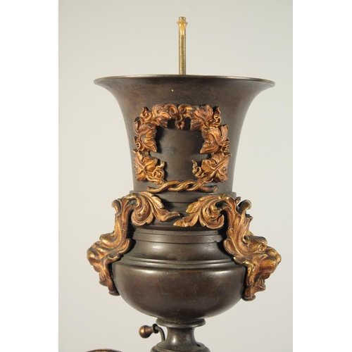 1321 - THOMAS MESSENGER. A REGENCY BRONZE AND ORMOLU TWO LIGHT CANDELABRA with outstretched arms and an urn... 