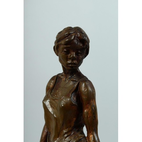 1328 - AFTER DEGAS A BRONZED STANDING FEMALE FIGURE on a square base. 13ins high.