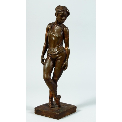 1328 - AFTER DEGAS A BRONZED STANDING FEMALE FIGURE on a square base. 13ins high.