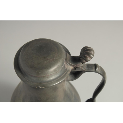 1336 - AN 18TH CENTURY PEWTER FLEMISH PEWTER FLAGON AND COVER. 11ins high.