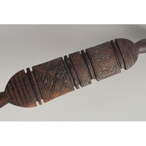 1341 - A SOUTH SEAS CARVED CLUB OR PADDLE. 2ft 3ins long.