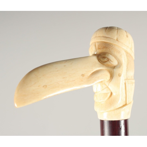 1366 - A CARVED BONE HANDLE WALKING STICK, 'LONG NOSE'. 3ft long.