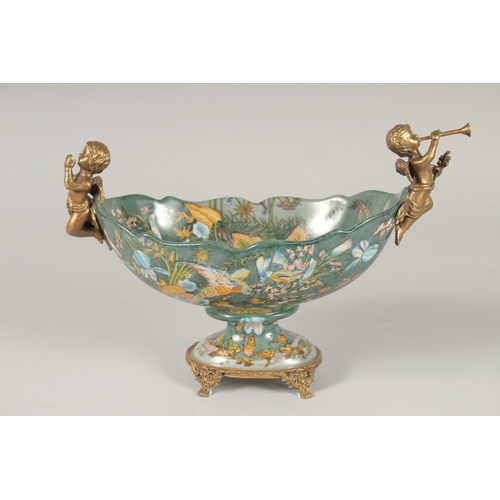 1384 - A BRONZE AND PORCELAIN OVAL BOWL with cherubs. 11ins long.