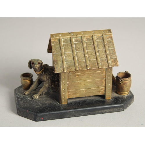 1411 - A BRONZE INKWELL, DOG IN A KENNEL on a marble base. 5ins long.