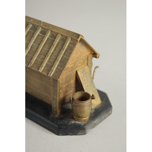 1411 - A BRONZE INKWELL, DOG IN A KENNEL on a marble base. 5ins long.