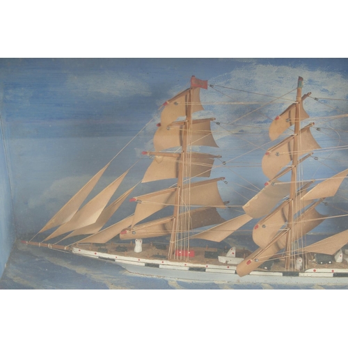 1437 - A MODEL OF A SHIP in a glass case. Case, 19ins x 12ins.