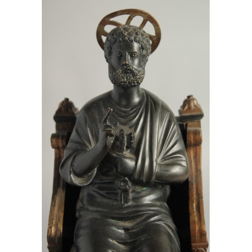 1456 - AFTER THE ANTIQUE. A 19TH CENTURY BRONZE SAINT SITTING ON A THRONE 14ins high.