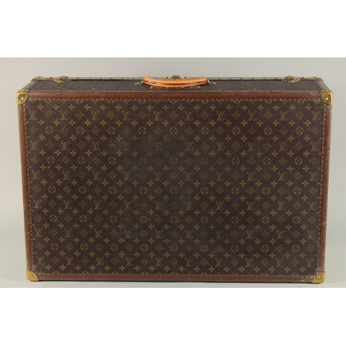 1498 - A LARGE LOUIS VUITTON SUITCASE. No. 1068754. With Louis Vuitton label. Lock no. 1262082. 31.5ins lon... 