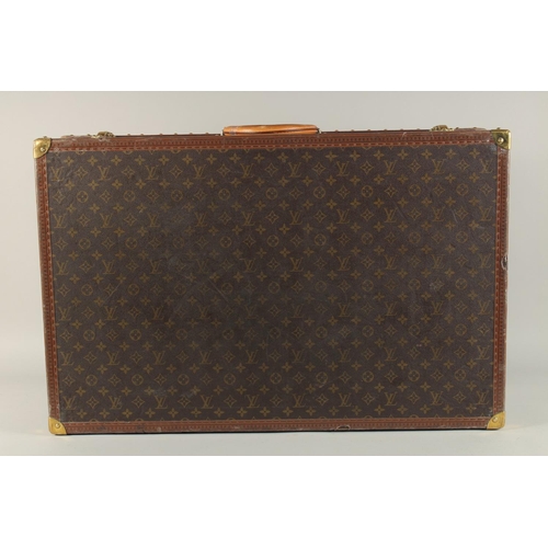 1500 - A LARGE LOUIS VUITTON SUITCASE. No. 1023430. With Louis Vuitton label. Lock no. 1252082. 31.5ins lon... 