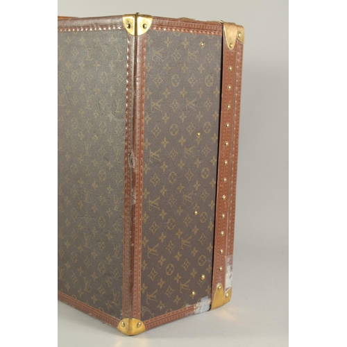 1500 - A LARGE LOUIS VUITTON SUITCASE. No. 1023430. With Louis Vuitton label. Lock no. 1252082. 31.5ins lon... 