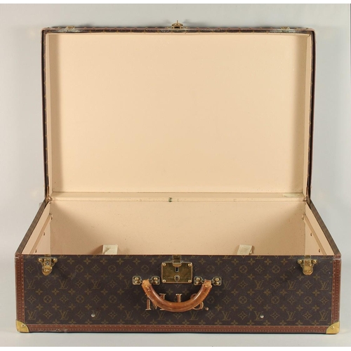 1500 - A LARGE LOUIS VUITTON SUITCASE. No. 1023430. With Louis Vuitton label. Lock no. 1252082. 31.5ins lon... 