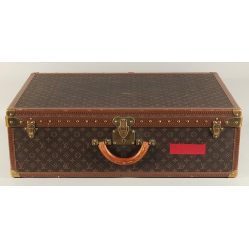 1502 - A LARGE LOUIS VUITTON SUITCASE. No. 981622. Label faded. Lock no. 1078192. 31.5ins long x 20.5ins wi... 