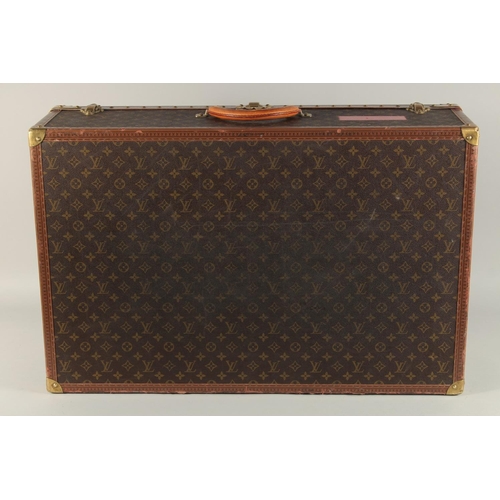 1502 - A LARGE LOUIS VUITTON SUITCASE. No. 981622. Label faded. Lock no. 1078192. 31.5ins long x 20.5ins wi... 