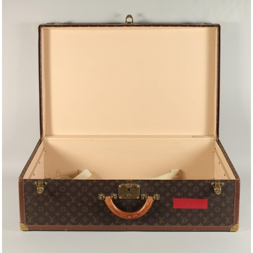 1502 - A LARGE LOUIS VUITTON SUITCASE. No. 981622. Label faded. Lock no. 1078192. 31.5ins long x 20.5ins wi... 