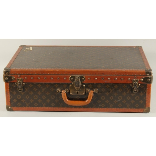 1504 - A LOUIS VUITTON SUITCASE. No. 810009 with Louis Vuitton label and ARTHUR GILBERT, New York. Lock no.... 