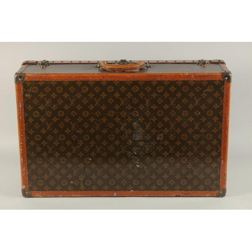 1504 - A LOUIS VUITTON SUITCASE. No. 810009 with Louis Vuitton label and ARTHUR GILBERT, New York. Lock no.... 