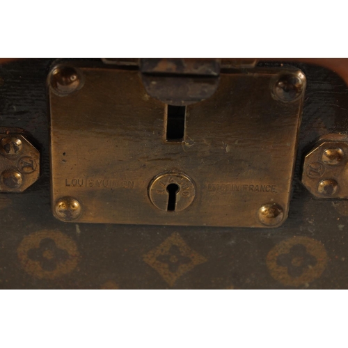 1504 - A LOUIS VUITTON SUITCASE. No. 810009 with Louis Vuitton label and ARTHUR GILBERT, New York. Lock no.... 