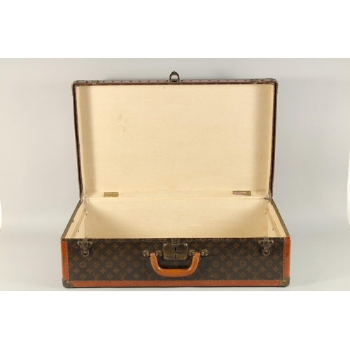 1504 - A LOUIS VUITTON SUITCASE. No. 810009 with Louis Vuitton label and ARTHUR GILBERT, New York. Lock no.... 