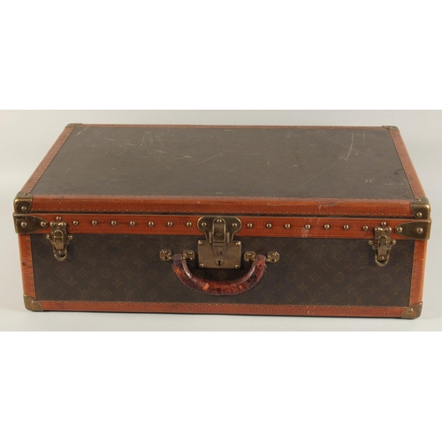 1505 - A LOUIS VUITTON SUITCASE. No. 82154 with Louis Vuitton label. Saks & Co., New York label. Pull-out t... 