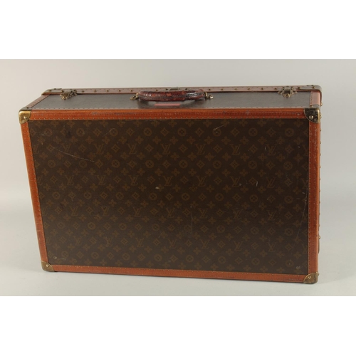 1505 - A LOUIS VUITTON SUITCASE. No. 82154 with Louis Vuitton label. Saks & Co., New York label. Pull-out t... 