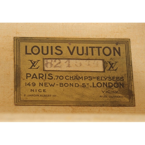 1505 - A LOUIS VUITTON SUITCASE. No. 82154 with Louis Vuitton label. Saks & Co., New York label. Pull-out t... 