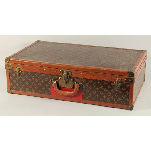 1507 - A LOUIS VUITTON SUITCASE. No. 771989 with Louis Vuitton label. FROM Saks & Co., New York. Lock no. 0... 