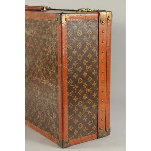 1507 - A LOUIS VUITTON SUITCASE. No. 771989 with Louis Vuitton label. FROM Saks & Co., New York. Lock no. 0... 