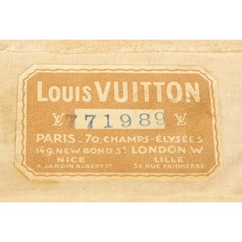 1507 - A LOUIS VUITTON SUITCASE. No. 771989 with Louis Vuitton label. FROM Saks & Co., New York. Lock no. 0... 