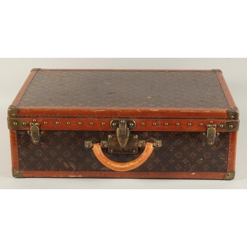 1508 - A LOUIS VUITTON SUITCASE. Label faint, also retail label faint, with lift-out tray. Lock no. 065564.... 