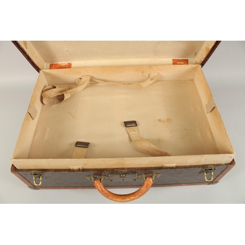 1508 - A LOUIS VUITTON SUITCASE. Label faint, also retail label faint, with lift-out tray. Lock no. 065564.... 