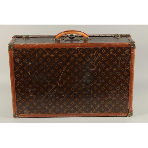 1508 - A LOUIS VUITTON SUITCASE. Label faint, also retail label faint, with lift-out tray. Lock no. 065564.... 