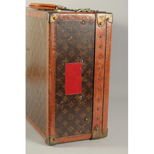 1508 - A LOUIS VUITTON SUITCASE. Label faint, also retail label faint, with lift-out tray. Lock no. 065564.... 