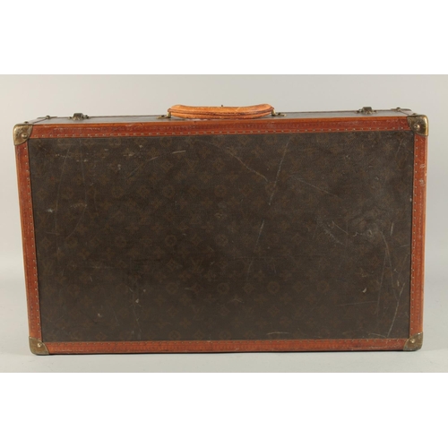 1509 - A LOUIS VUITTON SUITCASE. No. 816144, with Louis Vuitton label. Pull-out tray.  Lock No. 107170. 26i... 