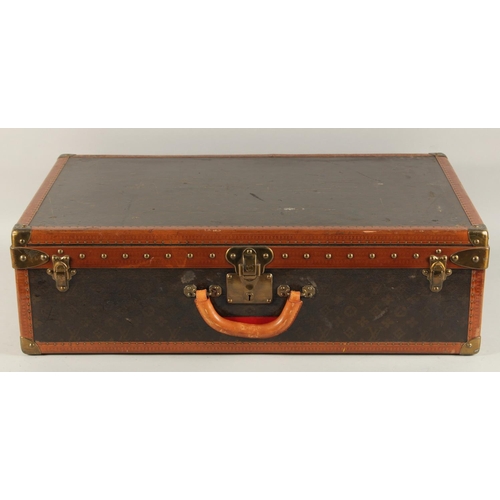 1510 - A LOUIS VUITTON SUITCASE. No. 819485, with Louis Vuitton label. From Arthur Gilbert, New York. With ... 