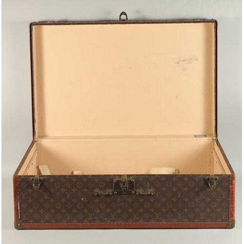 1511 - A LOUIS VUITTON SUITCASE. No. 920890, with Louis Vuitton label. Brass lock no 147171. Handle missing... 