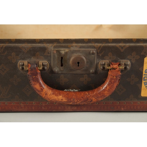 1513 - A LOUIS VUITTON SUITCASE. No. 788153, with Louis Vuitton label. Brass lock 113, with two labels SWED... 