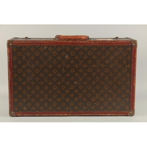 1513 - A LOUIS VUITTON SUITCASE. No. 788153, with Louis Vuitton label. Brass lock 113, with two labels SWED... 