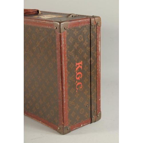 1513 - A LOUIS VUITTON SUITCASE. No. 788153, with Louis Vuitton label. Brass lock 113, with two labels SWED... 