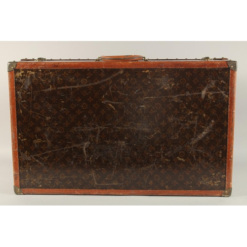 1514 - A LOUIS VUITTON SUITCASE. No. 81494, with Louis Vuitton label. Related label, bought from SAKS & Co.... 