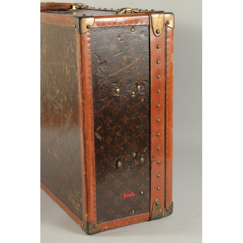 1514 - A LOUIS VUITTON SUITCASE. No. 81494, with Louis Vuitton label. Related label, bought from SAKS & Co.... 